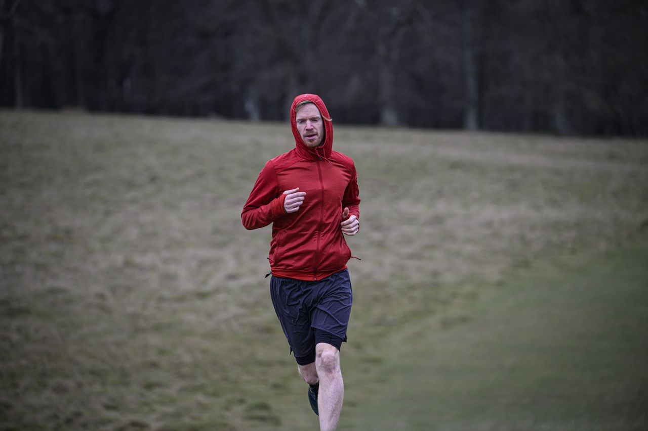 A man in a red jacket running