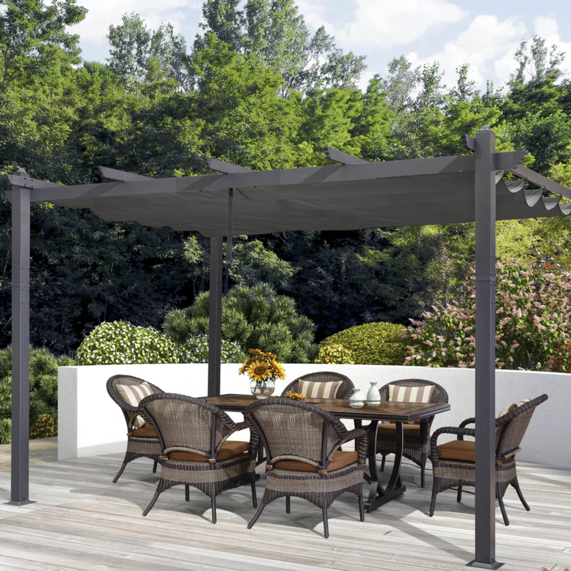 Outdoor decking space with black pergola and dining table with stripe cushions