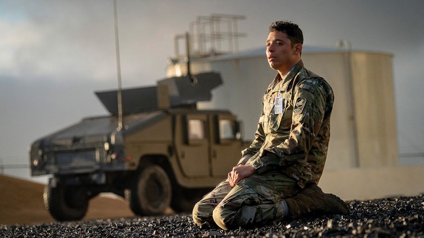 Anthony Ramos is shown on his knees in front of a vehicle in A House of Dynamite.