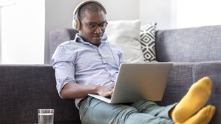 Man on sofa with laptop