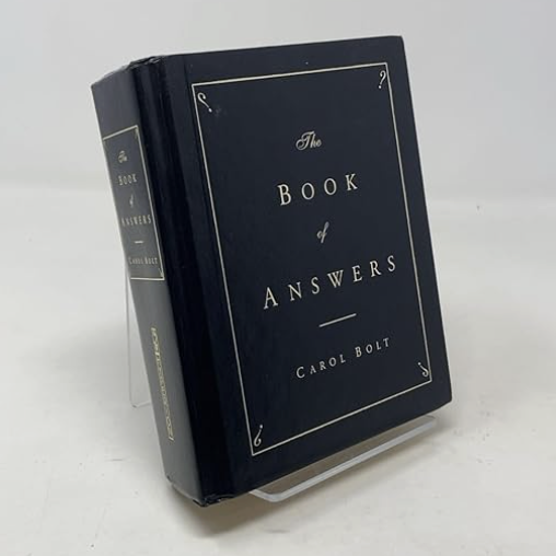 a copy of the book of answers in front of a plain backdrop
