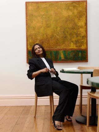 Zeenat Wilkinson wears a chic black suit and strappy heels.