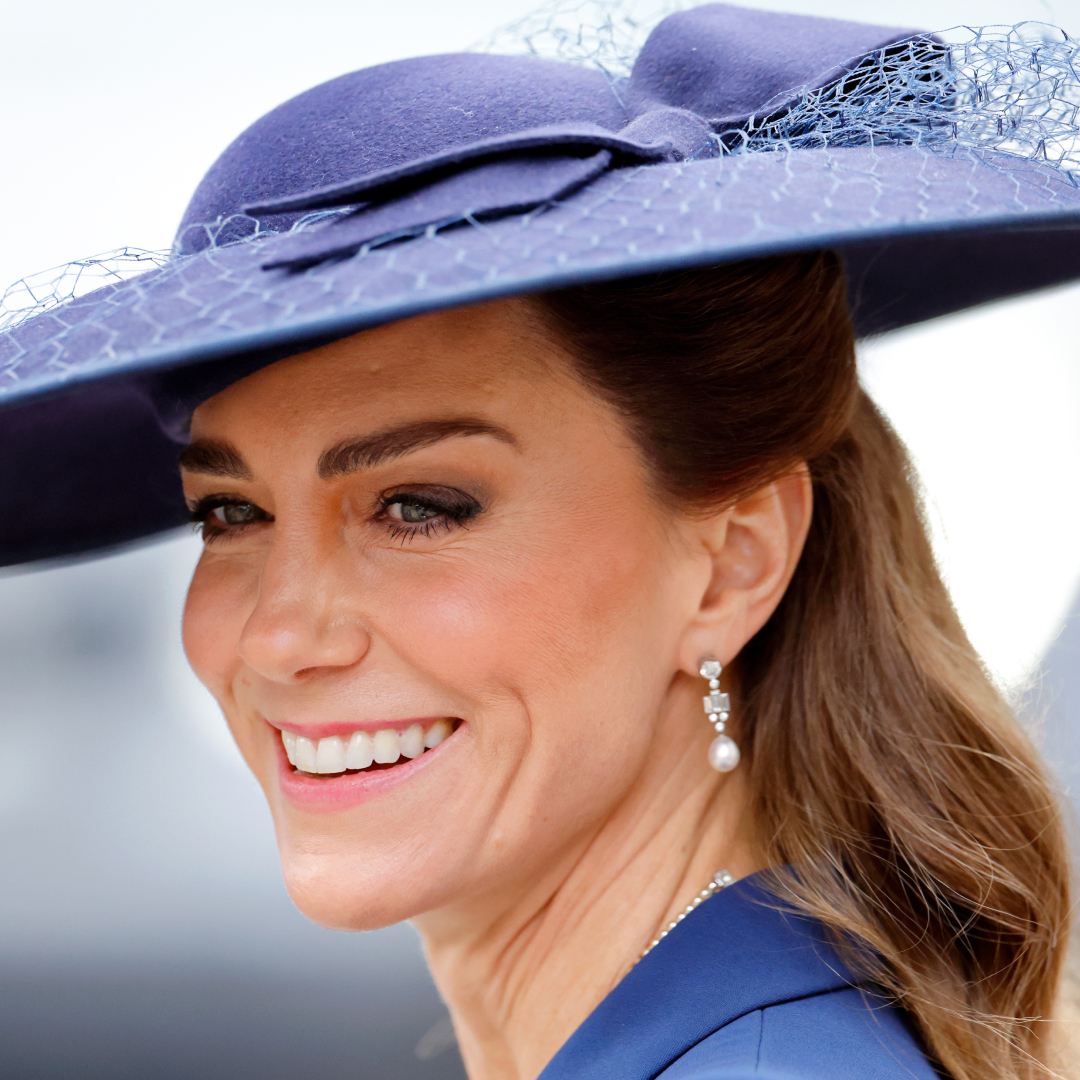 Princess Kate wearing a blue hat and smiling