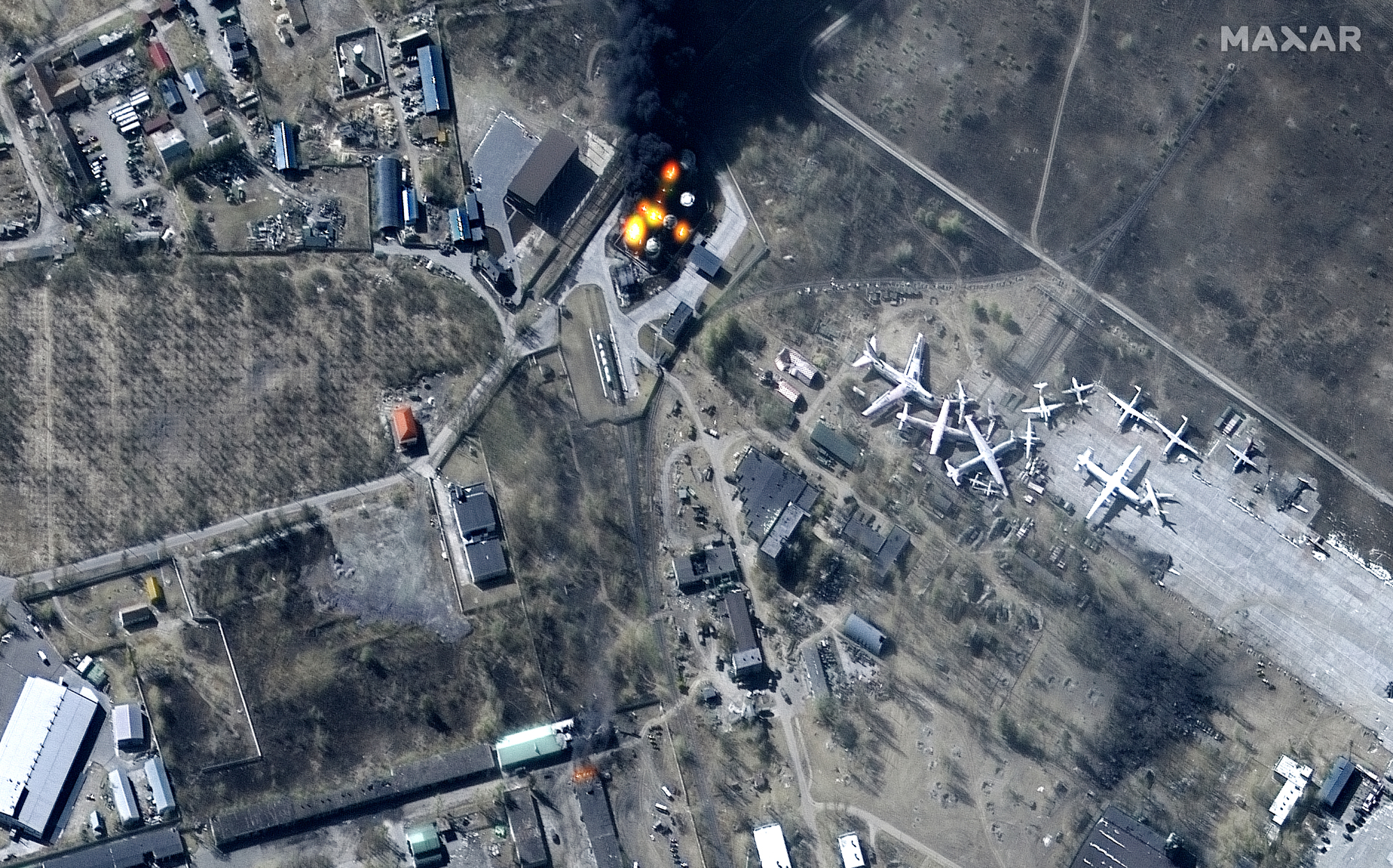 Multispectral satellite image showing damage to buildings and fuel storage tanks on fire at Antonov Airport in Ukraine on March 11, 2022 as seen by the WorldView-2 satellite for Maxar Technologies.