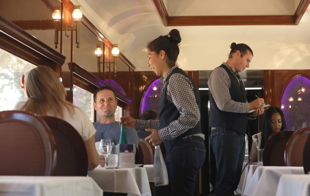 Jessica Brooks (left) and James Brooks (middle left) from Brentwood celebrate their one year anniversary on the Napa Valley Wine Train, as they enjoy ordering lunch on the Napa Wine Train on Friday, Aug. 30, 2019 in Napa, Calif.