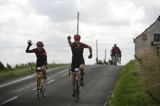 Triumphant riders celebrate reaching a rare downhill stretch of the challenging route.