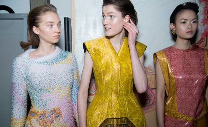 Models wear colourful Bauhaus-inspired corset tops, whilst another wears a fluffy embellished jumper
