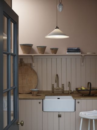 Pink kitchen with panelled walls