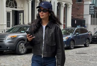 stores like anthropologie shown in a photo of a woman wearing a leather jacket over a white t-shirt and jeans