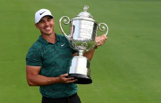 Brooks Koepka holds the Wanamaker Trophy in 2018