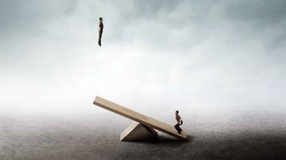 A man jumps onto a seesaw, propelling another man into the air.