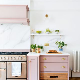 kitchen with pink cabinets and gas counter