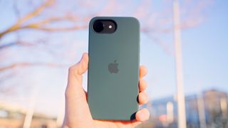 iPhone 16e - Holding up outdoors