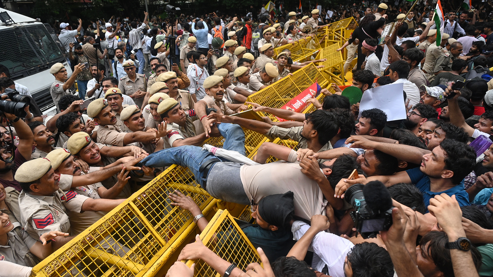 Supporters of India's Cockroach Janta Party scuffle with police as they attempt to march on Parliament House to demand the resignation of the education minister, in New Delhi, India