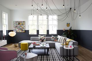 a modern living room with large overhead spider light