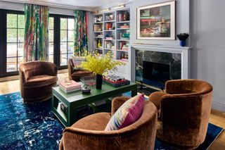 a colorful living room with armchairs