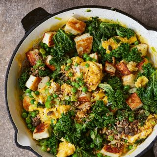 Dish of cubes of halloumi, kale, peas and egg