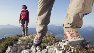 how to break in hiking boots: modern boots on a rock