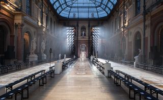 Shows the architectural elements of the Parisian school's hall which were left bare, and the floor mosaics became the catwalk.