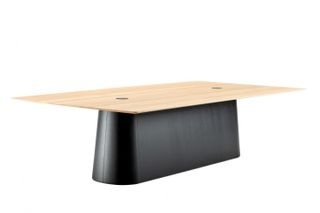 A table with black oval base and large wooden top