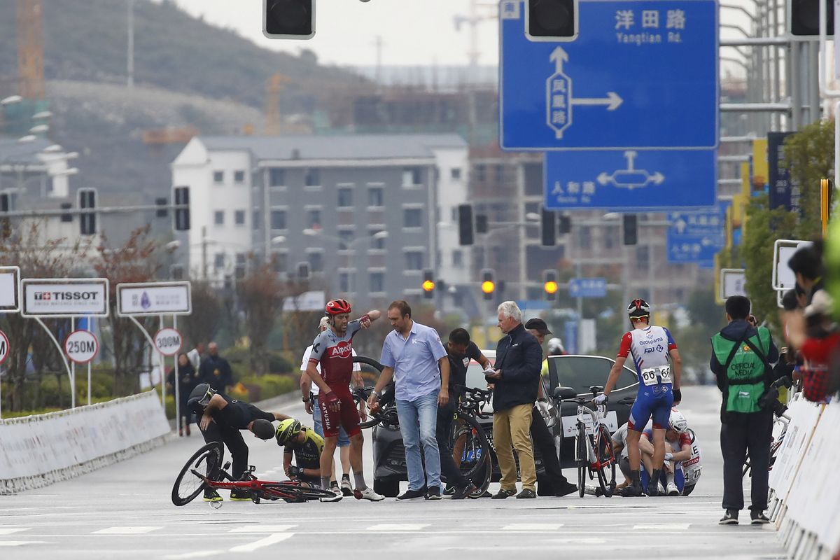 Riders pick themselves up after a crash in the finish straight