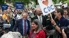 CDC leaders who quit over Trump administration policies walk through a "clap line" outside agency.