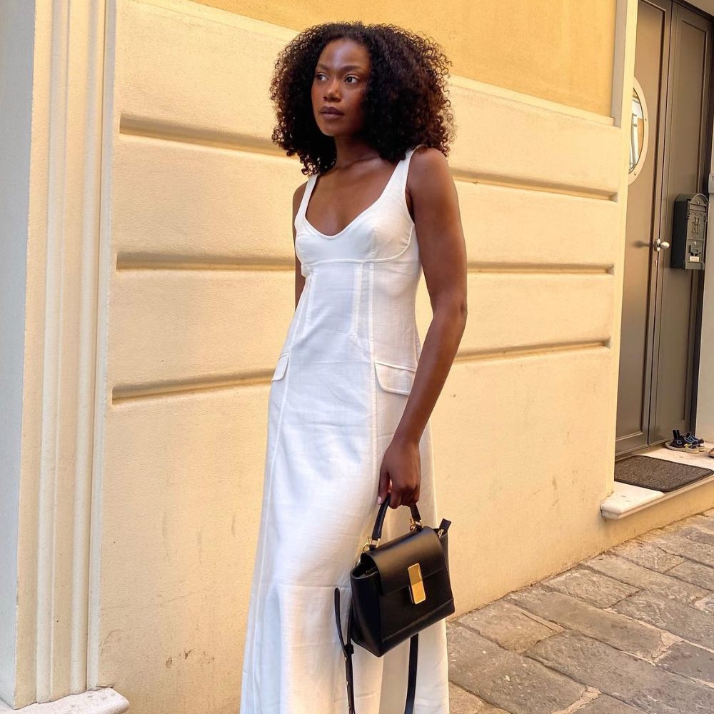Influencer wears a white dress.