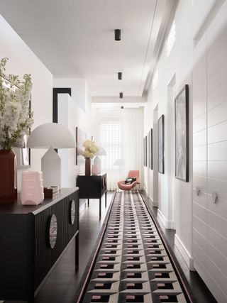 two symmetrical console tables in a hallway