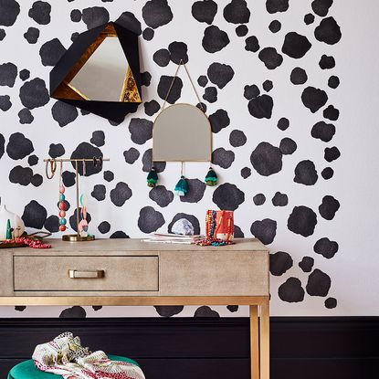 room with dalmatian print wall and wooden table 