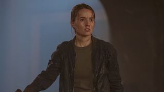 Abby in jacket holding Tommy at gunpoint in The Last of Us Season 2 finale