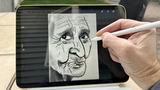 Hånd der tegner på en iPad med en Apple Pencil