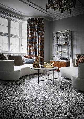 Animal print rug in living room with sofas and chairs glamour leopard print