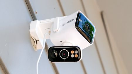 TP-Link Tapo C675D security camera mounted to the side of a house