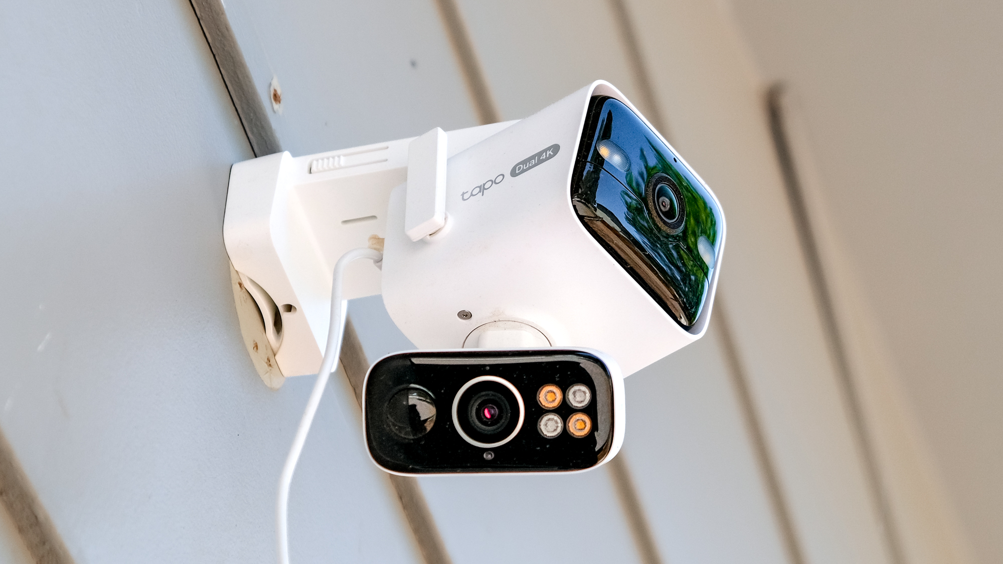 TP-Link Tapo C675D security camera mounted to the side of a house