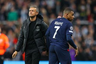 Kylian Mbappe of Paris Saint-Germain walks past Luis Enrique, manager of Paris Saint-Germain, during the UEFA Champions League match between Newcastle United FC and Paris Saint-Germain at St. James Park on October 04, 2023 in Newcastle upon Tyne, England. (Photo by James Gill - Danehouse/Getty Images) PSG