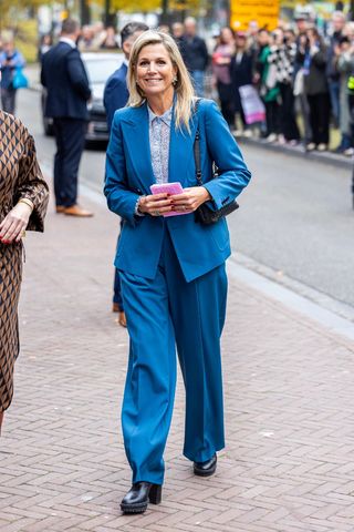 Queen Máxima of The Netherlands wears a blue suit as she visits the Dutch Design Week on October 26, 2023 in Eindhoven, Netherlands.