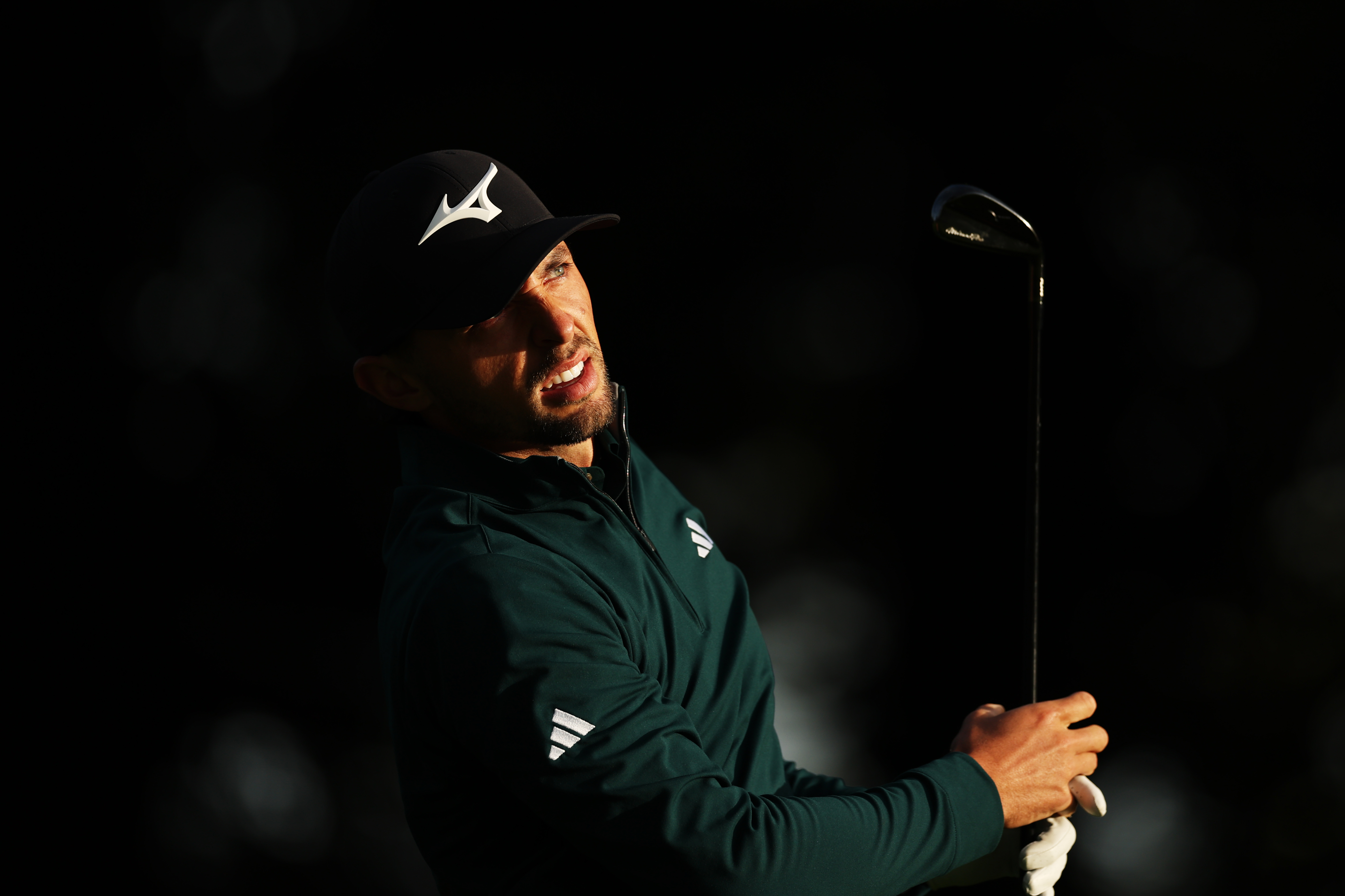 Marco Penge watches the ball flight of his 2-iron