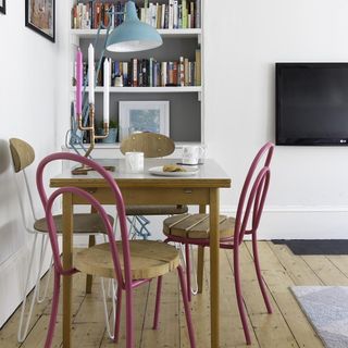 safest area wooden table and chairs with tv on wall