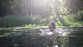 Woman wild swimming in a lake