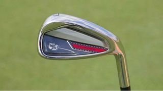 The Wilson Dynapower iron showing off their grey and red colorway on the golf course