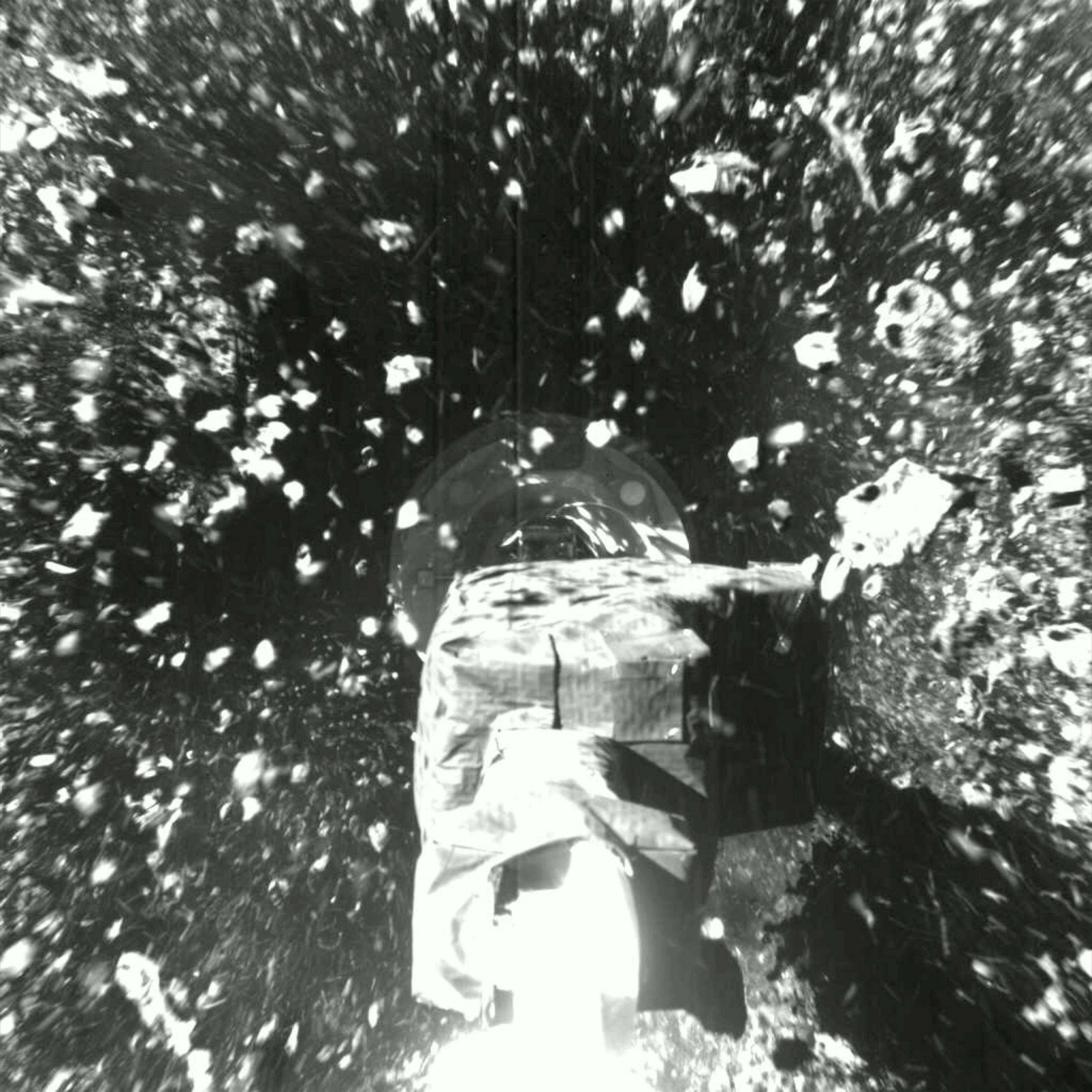 An image of the rocks from Bennu's rubble-pile surface flying in all directions as OSIRIS-REx touches down. Some of the asteroid's surface, or regolith, was captured inside the spacecraft's sample retrieval container.