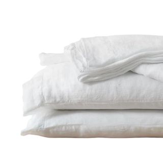 A pile of white linen bedding