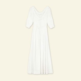 A cutout of a white Dôen dress on a cream background