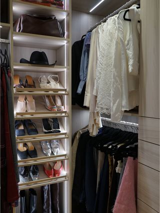 A photo of a portion of Kat's closet with her shoes and blouses hung up.