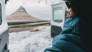 winter sleeping bag: hiker in back of van in Iceland
