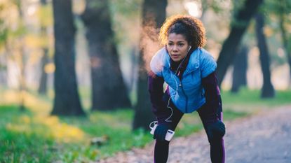 Respiratory system: A woman breathes into the cold as she takes a break from exercising.