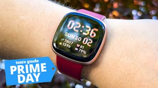 fitbit versa 4 on a wrist with prime day deal tag