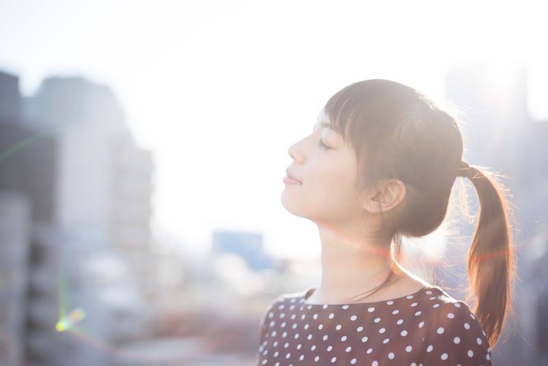 A woman takes a break from work to take a deep breath.