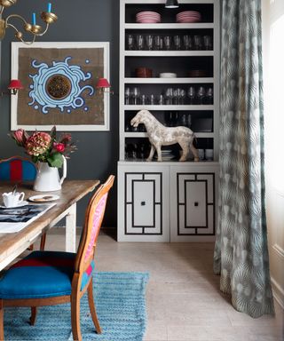 Grey dining room with alcove shelving unit and grey walls