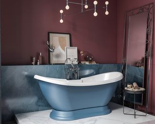 Sky blue bathtub in berry painted bathroom by Blue Sky Bathrooms